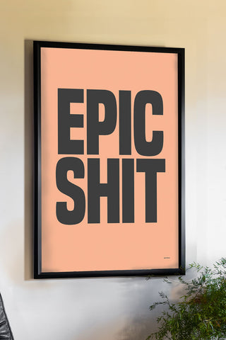 The Epic Shit Coral & Black Art Print - Unframed displayed in a black frame on a neutral wall above a plant.