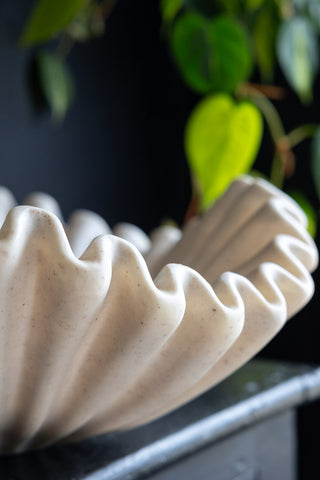 Close-up of the rippled edge of a large cream bowl.