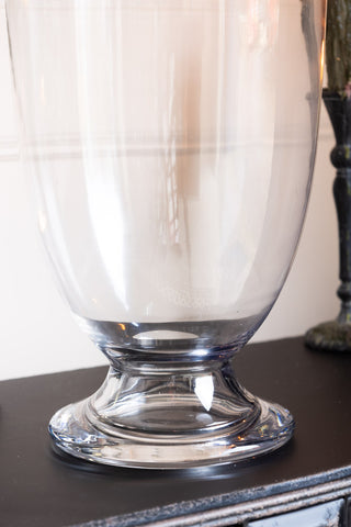 The base of the clear glass apothecary jar with a domed lid, perfect for decorative or functional use.