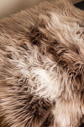 Close-up of the Faux Sheepskin Rug in White & Walnut.