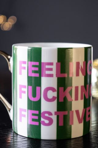 Close-up of the text on the Feeling Fucking Festive Stripe Mug.