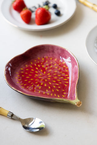 The Beautiful Fig Serving Dish styled with a plate of berries and a spoon.