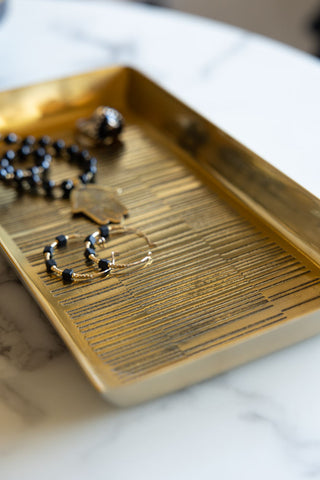 Close-up of the Fine Line Detail Gold Effect Trinket Tray styled with some jewellery inside.