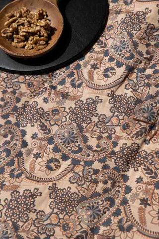 The Floral Paisley Bench Seat Pad styled with serveware and walnuts.