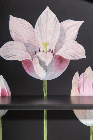 Close-up of the floral design and one of the shelves on the Floral & Black Metal Display Shelves.