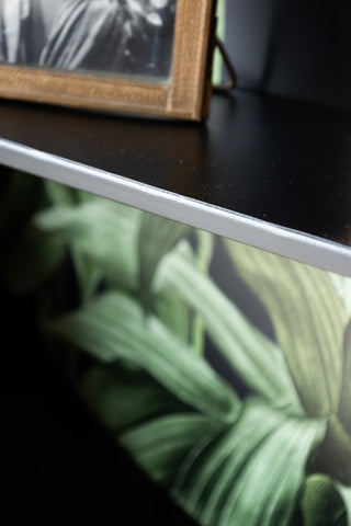 Close-up of the edge of one of the shelves on the Floral & Black Metal Display Shelves.