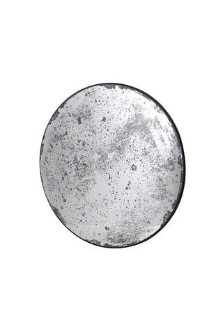 Cutout of a round antique-style mirror on a white background.