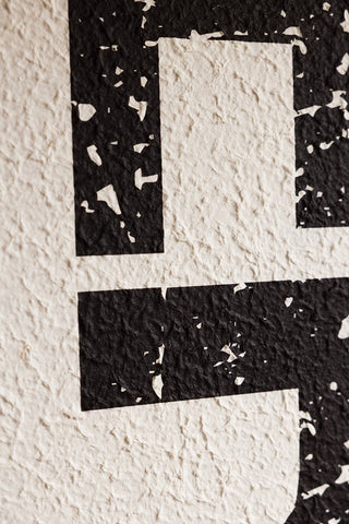 Detail shot of the design of the Framed Black & White Merci Wall Art.