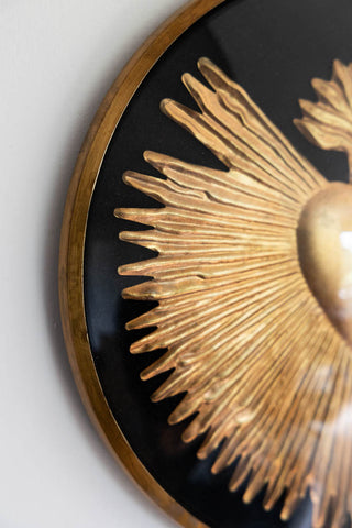 Detail shot of the Framed Golden Milagro Heart Decoration displayed on a white wall.