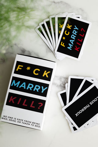 The Fuck, Marry, Kill Card Game displayed on a marble surface, showing its contents.