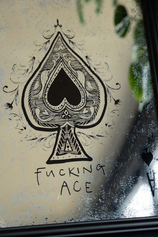 Close-up of the text and ace motif on the Fucking Ace Decorative Playing Card Mirror.