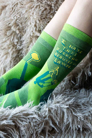 The Fucking Beautiful Lawn Men's Socks worn by a model with a fluffy backdrop.