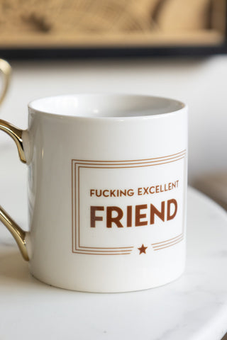 A close-up of a white mug with the words 'F*cking Excellent Friend' written on it 