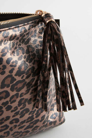 Close-up of the tassel zip of the Glam Leopard Print Clutch Bag.