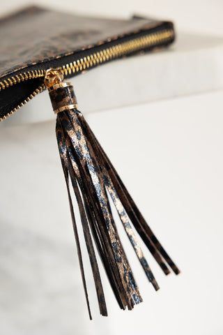 Close-up of the tassel zip on the Glam Leopard Print Clutch Bag.