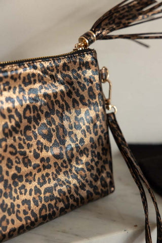 Close-up of the Glam Leopard Print Clutch Bag displayed on a shelf.