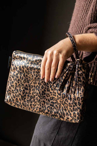 The Glam Leopard Print Clutch Bag being worn on a model