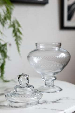 The Glass Footed Jar displayed on a white table with the lid off.