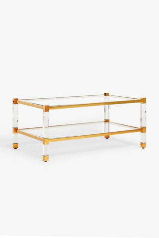 Cutout of the Gold & Glass Coffee Table seen from a side angle, on a white background.