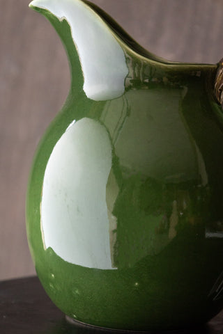 green jug showing white marks and bubble dents