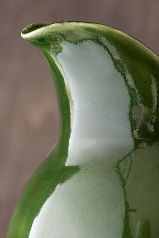 The spout of the green glazed jug.