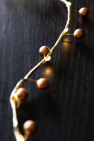 Close-up of the gold berry light on a table.