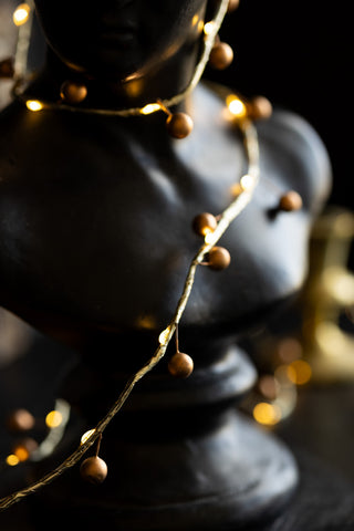 Gold Berry Decorative Light Chain wrapped around bust detail