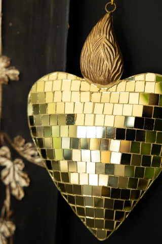 The Disco Ball Flaming Heart Decoration styled on a black unit 