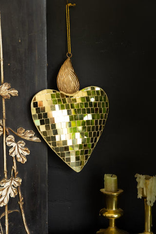 The Disco Ball Flaming Heart Decoration styled on a black unit with some candlestick holders