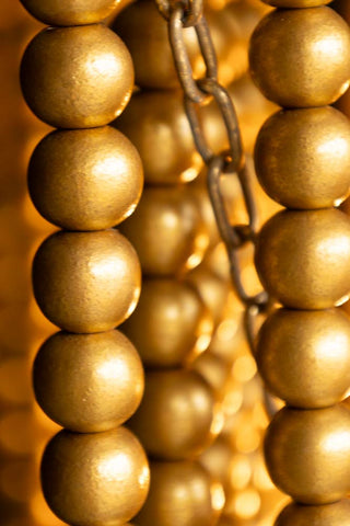 Close-up of the beads and chain on the Gold Star Shaped Beaded Statement Chandelier Light.