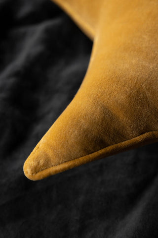 Close-up of one of the corners of the Velvet Star Cushion In Gold.