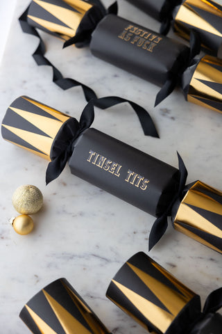 A close up of the black and gold tinsel tits cracker.