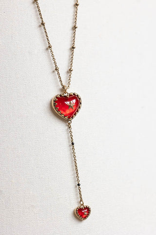 The Gold & Red Heart & Star Layered Chain Necklace on a neutral background.