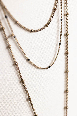 Detail shot of the chains on the Gold & Red Heart & Star Layered Chain Necklace.