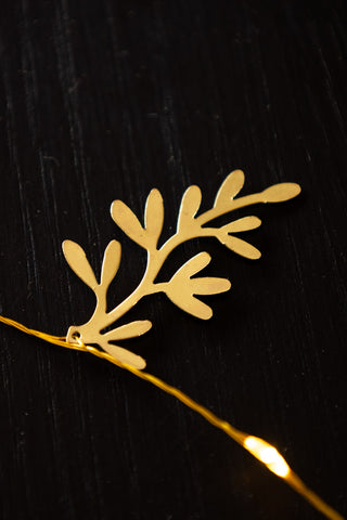 Golden fern leaf on a gold light chain