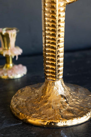 Close-up of the base of the Gorgeous Gold Cactus Candle Holder, with a candlestick holder in the background.