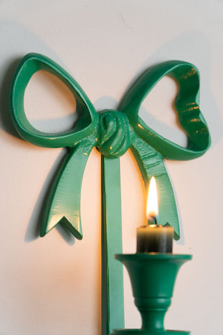 Close-up of the bow detail on the Green Bow Wall-Mounted Candle Holder.