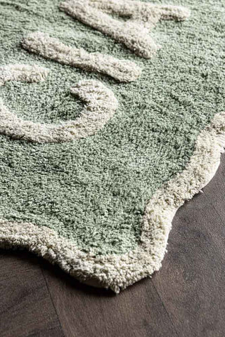 Detail shot of one corner of the Green Ciao Bath Mat.