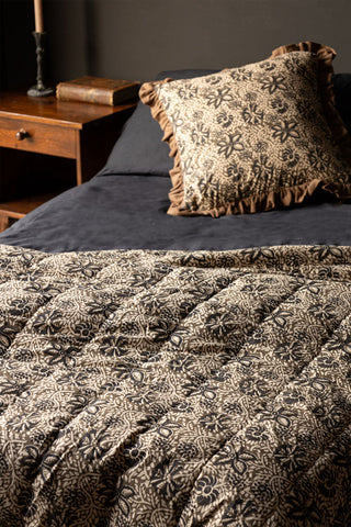 The Green Floral Quilt in King-Size styled on a bed with a matching cushion.