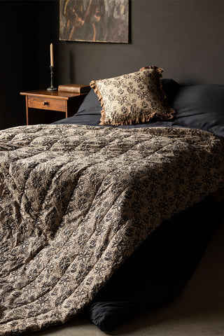 The Green Floral Quilt in King-Size styled draped across a bed.