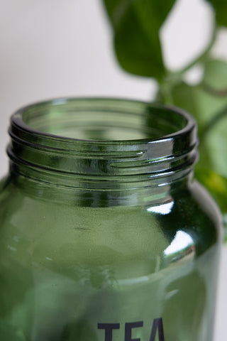 Close-up of the top of the Green Glass Storage Jar With Black Lid - Tea.