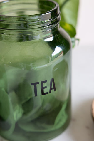 Close-up of the text on the Green Glass Storage Jar With Black Lid - Tea.