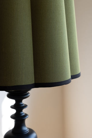 Detail shot of the Green Scalloped Easyfit Lampshade, displayed on a lamp base.