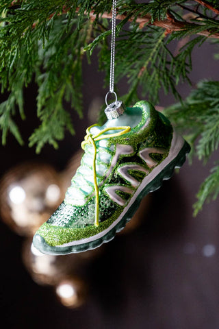 Green Trainer Christmas Tree Decoration hanging from greenery branch