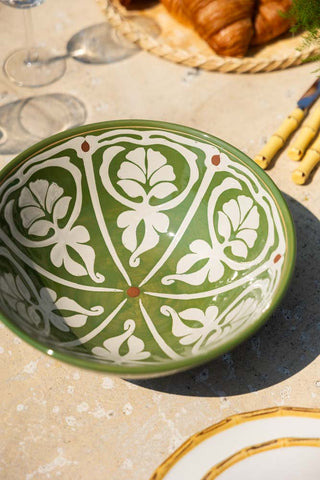 The Green & White Rustic Salad Bowl styled on an outdoor dining table in the sunshine.