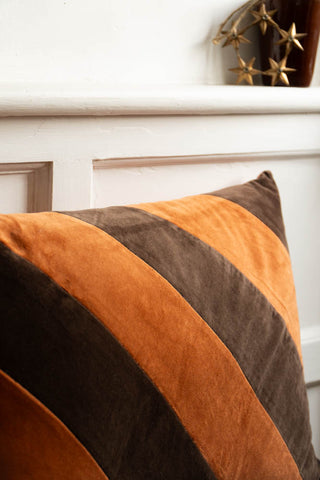 Close-up of one corner of the HKLiving Coffee & Mocha Striped Velvet Cushion.