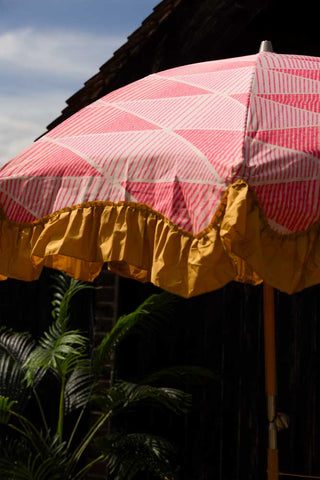 Close-up of the HKliving Pink Linear Parasol with Mustard Fringe.
