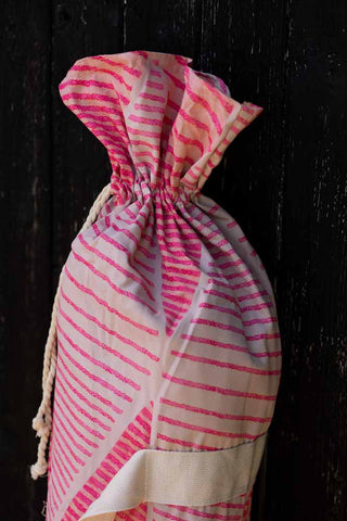 Close-up of the HKliving Pink Linear Parasol with Mustard Fringe bag.