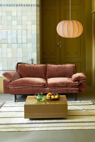 The HKliving Retro 2 Seater Sofa in Magnolia Velvet styled with a rug, coffee table, fruit bowl, jug and pendant light.