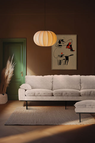 The HKliving Retro 4 Seater Sofa in Taupe Boucle styled in a living room on a rug with the matching footstool, with an art print, pendant light and large pampas grass stems in a pot.